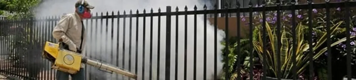 Mosquito control technician fogging a yard perimeter for mosquito reduction in Nashville, TN